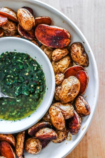 A bowl of crispy oven roasted potatoes with chimmichuri