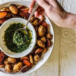 Oven roasted potatoes in a serving bowl with a bowl of chimichurri