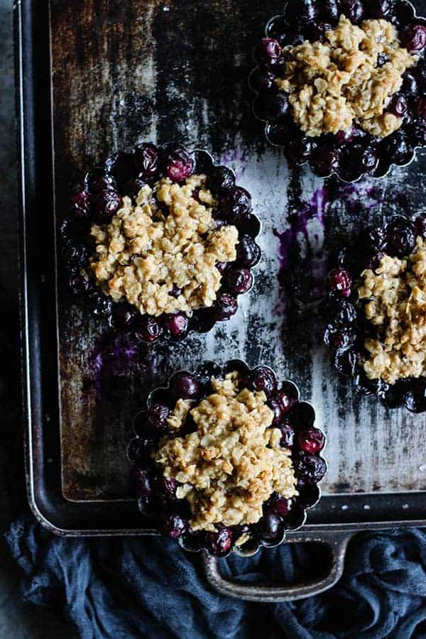 4 Individual Blueberry Crisps on a serving platter .