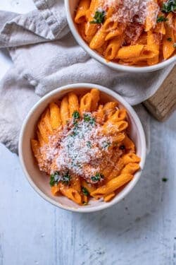 A bowl of penne pasta that has been tossed with homemade marinara sauce recipe