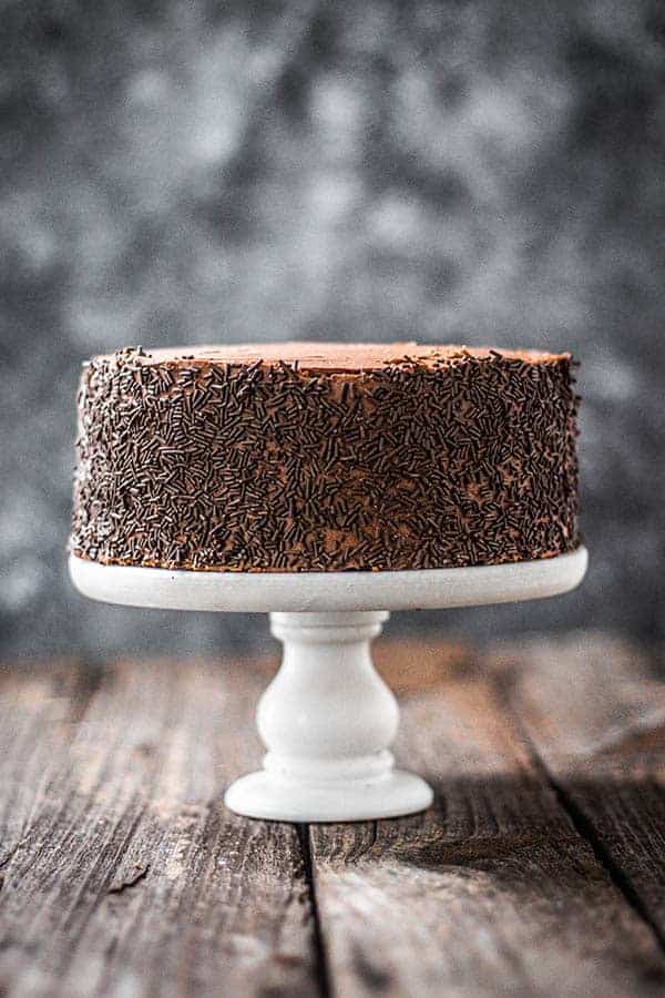 A 2-layer, iced version of our Easy Chocolate Cake recipe. It is frosted with chocolate icing and the sides are coated in chocolate sprinkles.