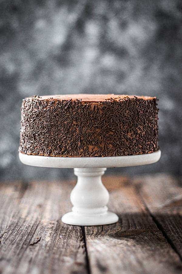  A 2-layer, iced version of our Easy Chocolate Cake recipe. It is frosted with chocolate icing and the sides are coated in chocolate sprinkles. 