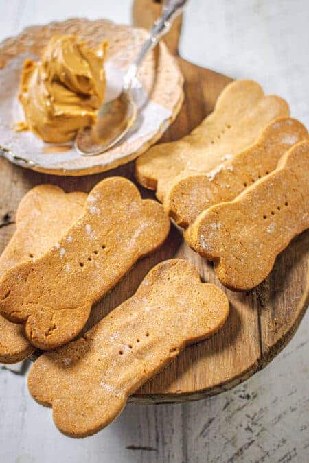 A close up of bone shaped, baked peanut butter dog treats