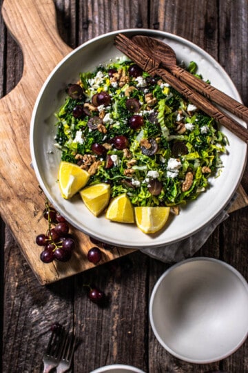 A bowl of Kale Salad with Red Grapes, Walnuts, and Feta