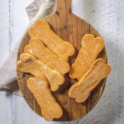 Baked dog treats on a wooden serving board