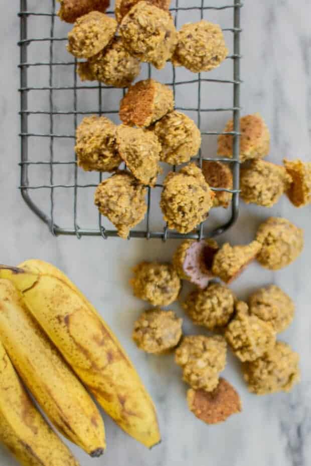 Can Dogs Eat Bananas? Bananas in their peel on a counter next to homemade banana bread dog treats.