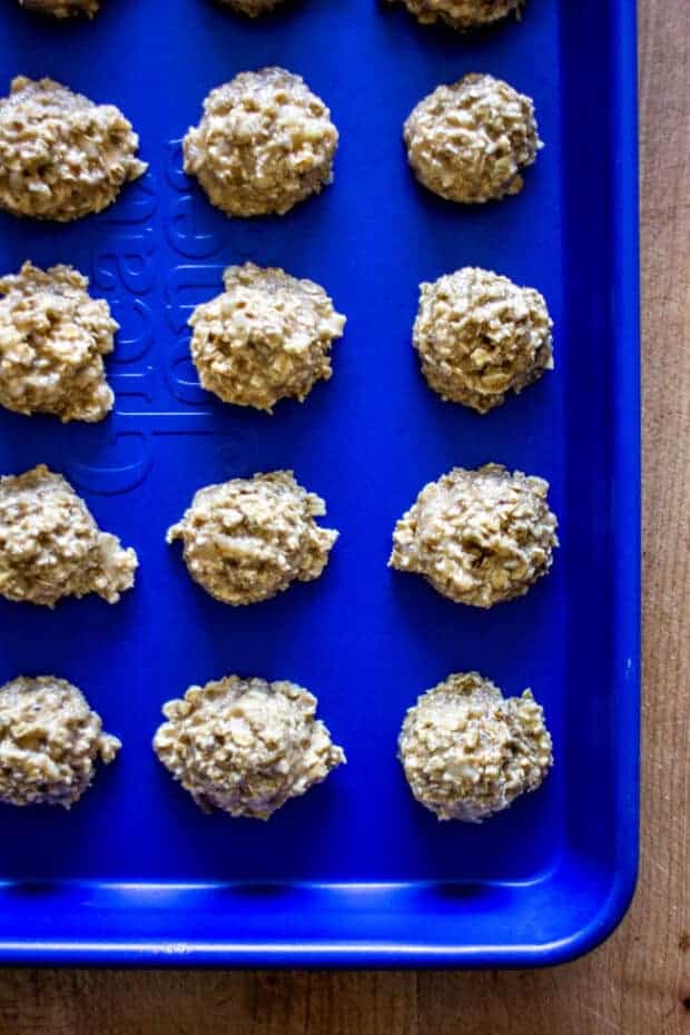 Banana bread dog treats on a blue sheet pan ready to be baked.