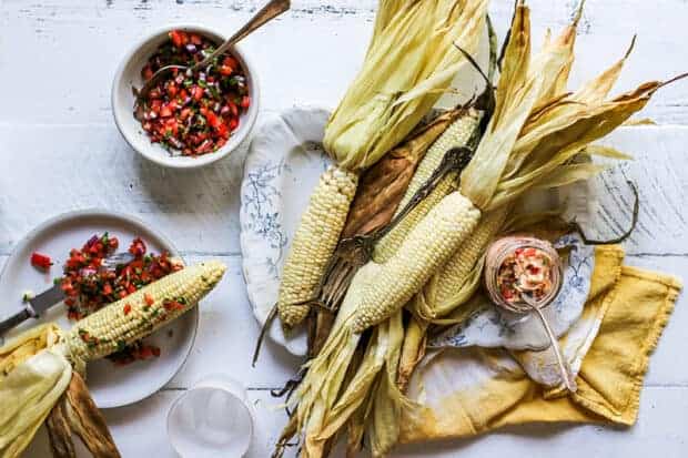 A platter of oven roasted corn and pico de gallo butter.