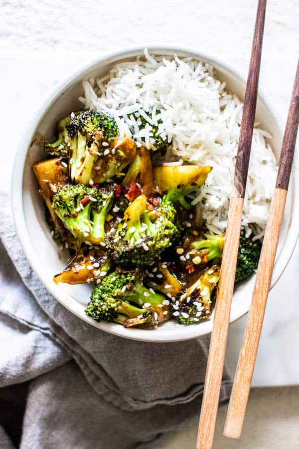 Broccoli Stirfry in a bowl with steamed white rice ready to serve.