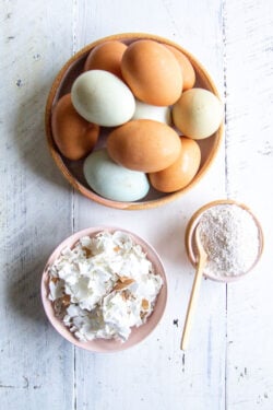 A bowl of eggs, a bowl of eggshells, and a bowl of DIY eggshell supplement powder.