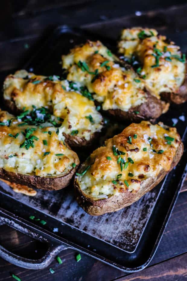 5 twice baked potatoes on black background