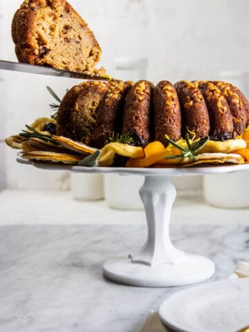 A slice being removed from a Fruitcake-Inspired Bundt Cake