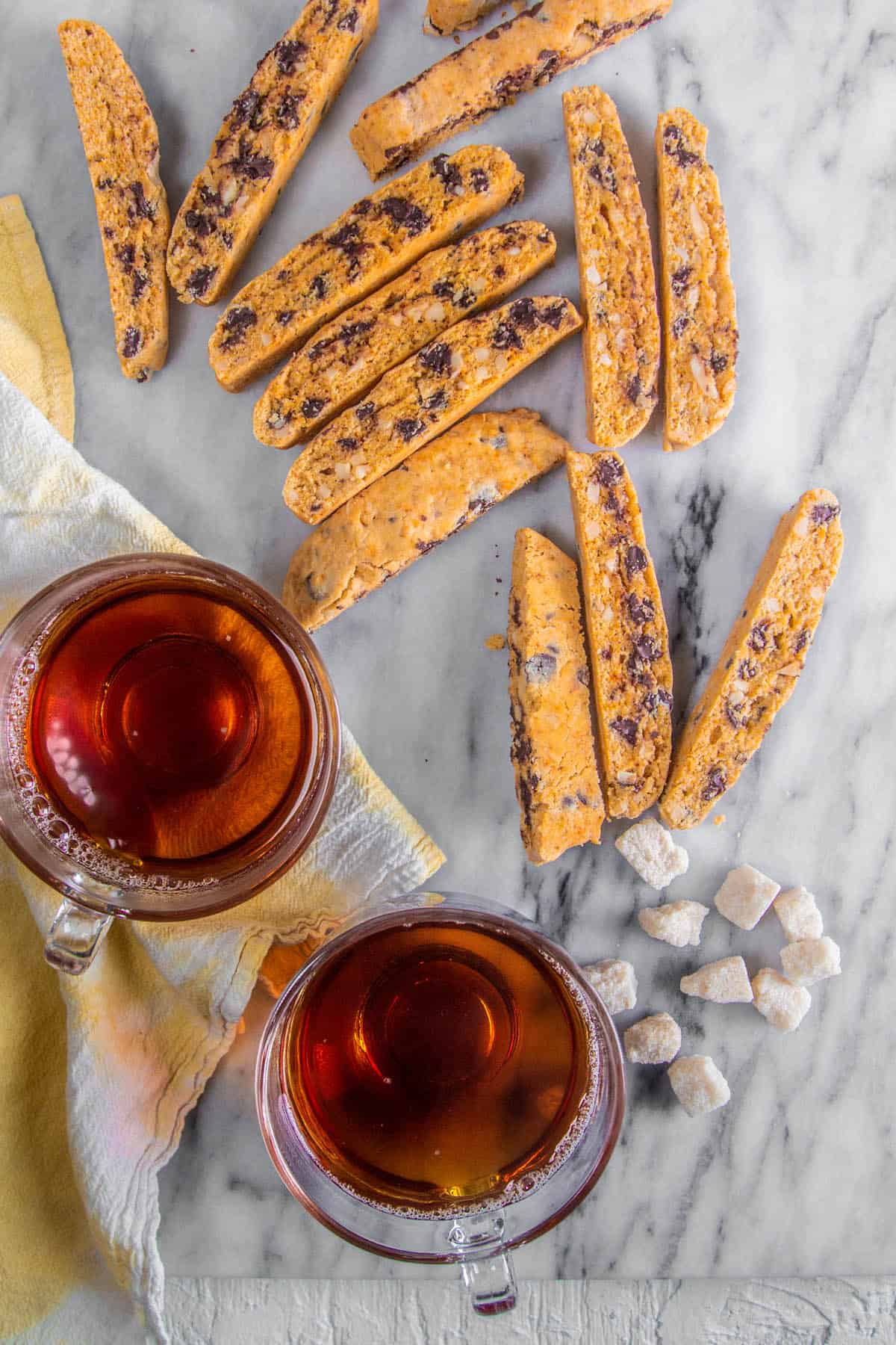 Biscotti on a white background with sugar cubes & tea