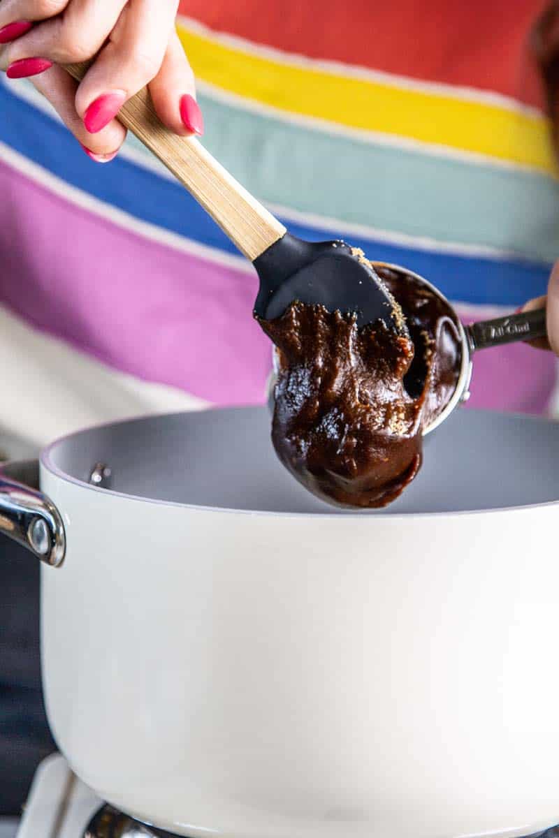 scooping prune puree out of measuring cup