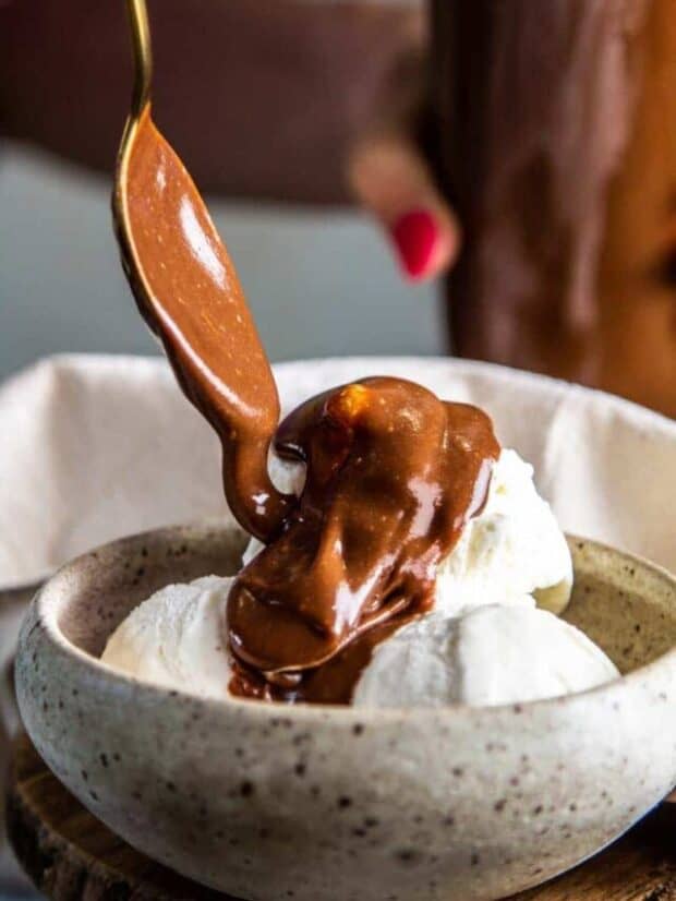 pouring chocolate sauce over ice cream