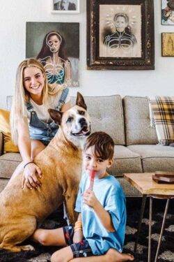 a girl, boy, & a dog sitting near a couch