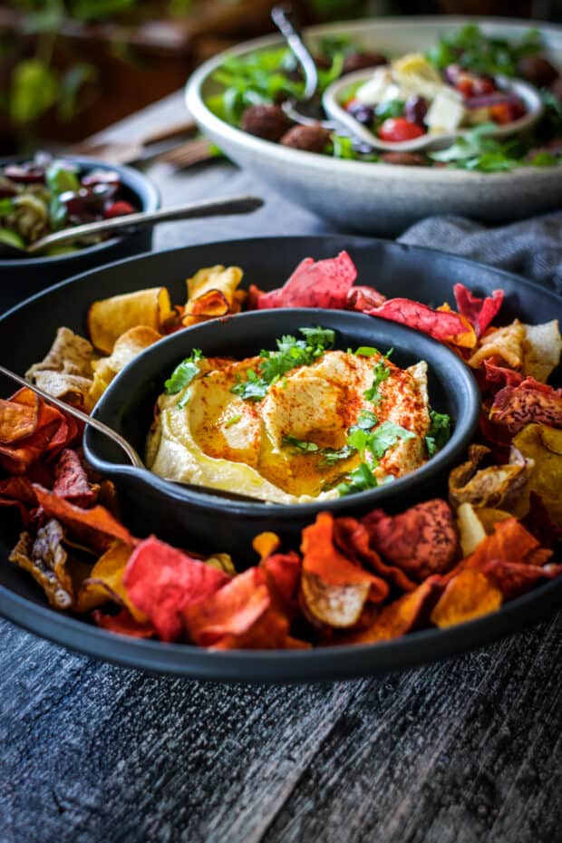 close up of hummus bowl & vegetable chips