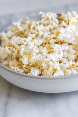 a white bowl full of tajin popcorn