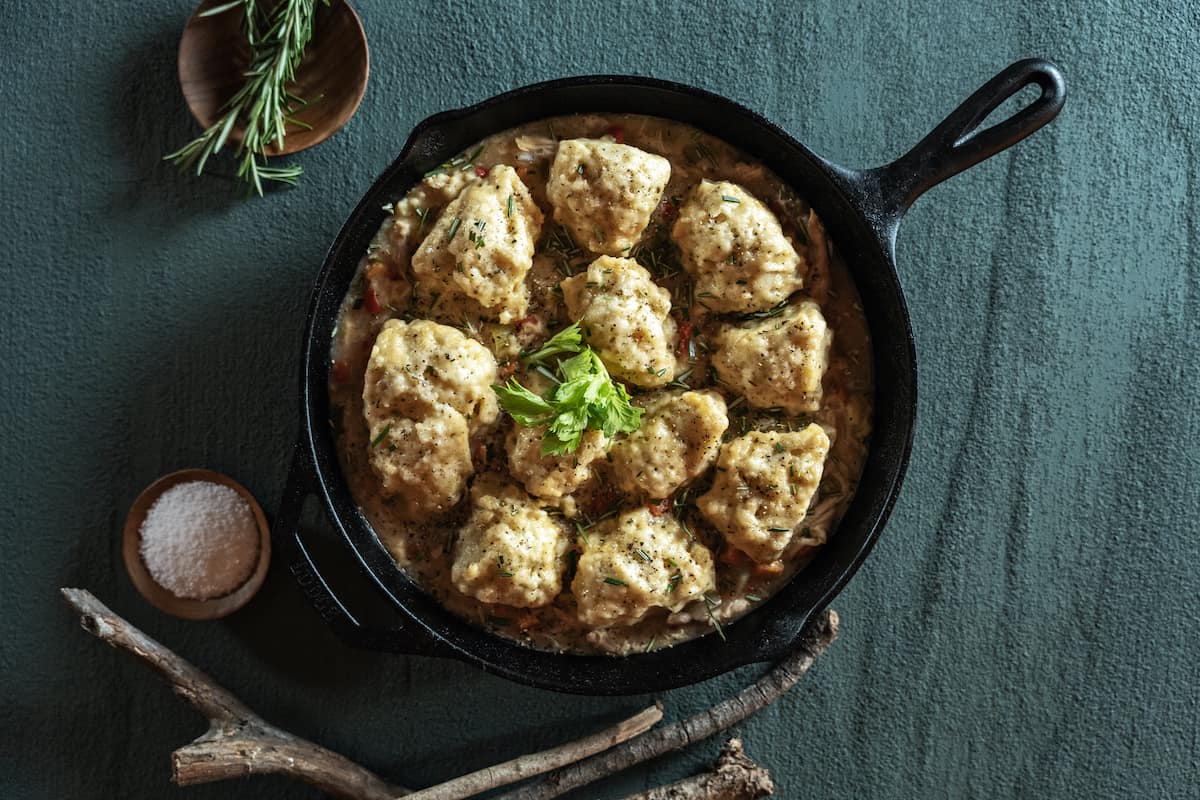 chicken and dumplings in skillet with rosemary and salt