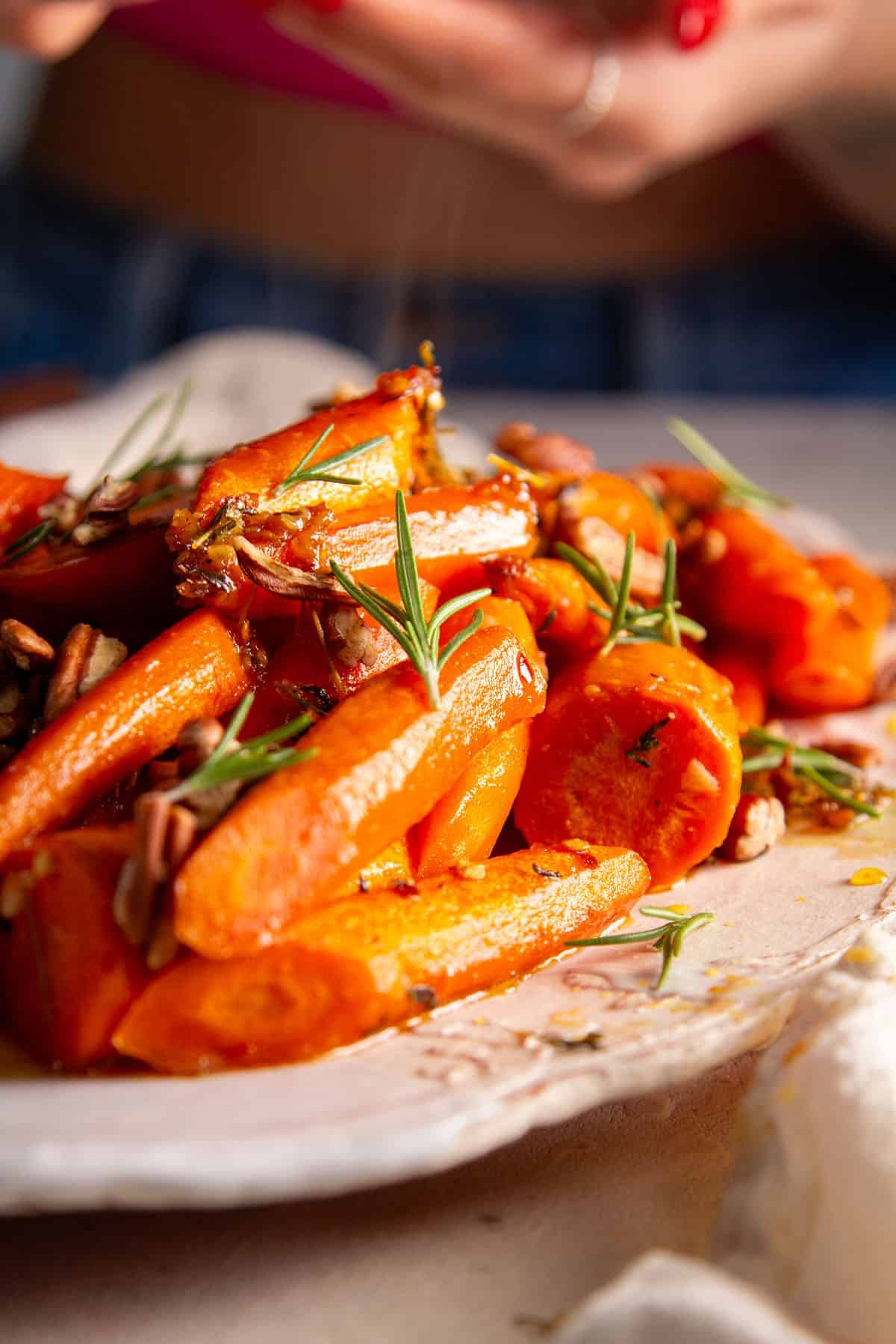 steaming carrots on white plate