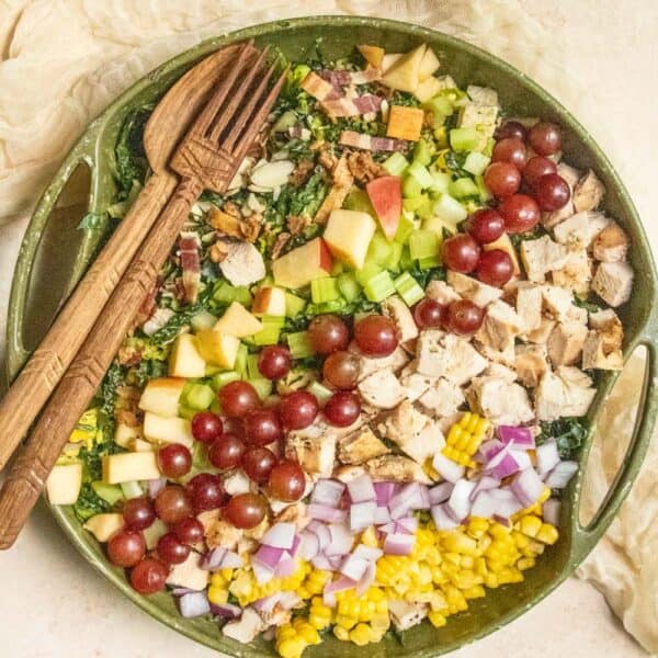 A large chopped salad in a green bowl.