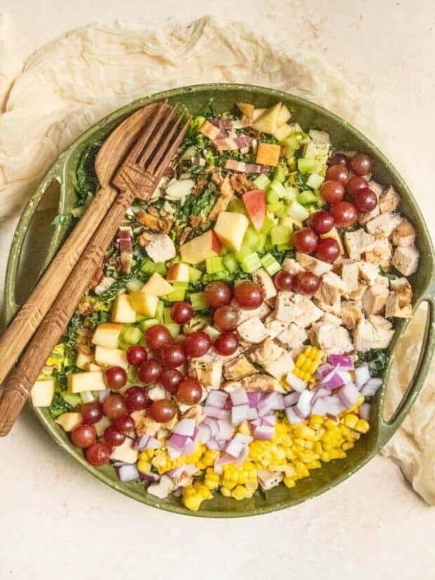 A large chopped salad in a green bowl.