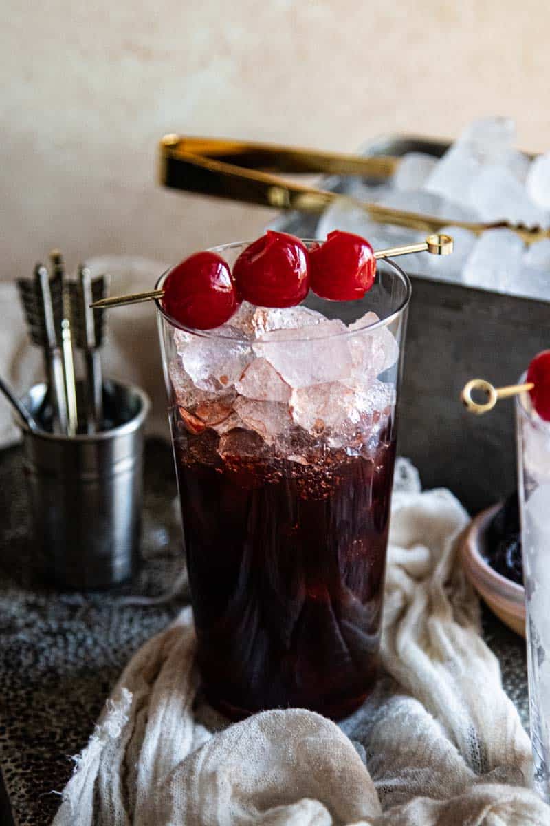 glass filled with ice and cherry dr. pepper syrup