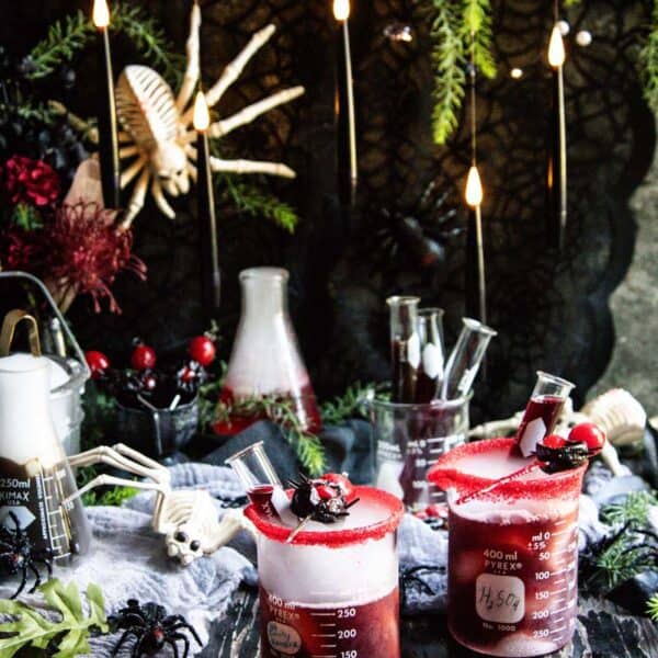 A spooky Halloween set up with spider decorations and cocktails fizzing and bubbling with dry ice.