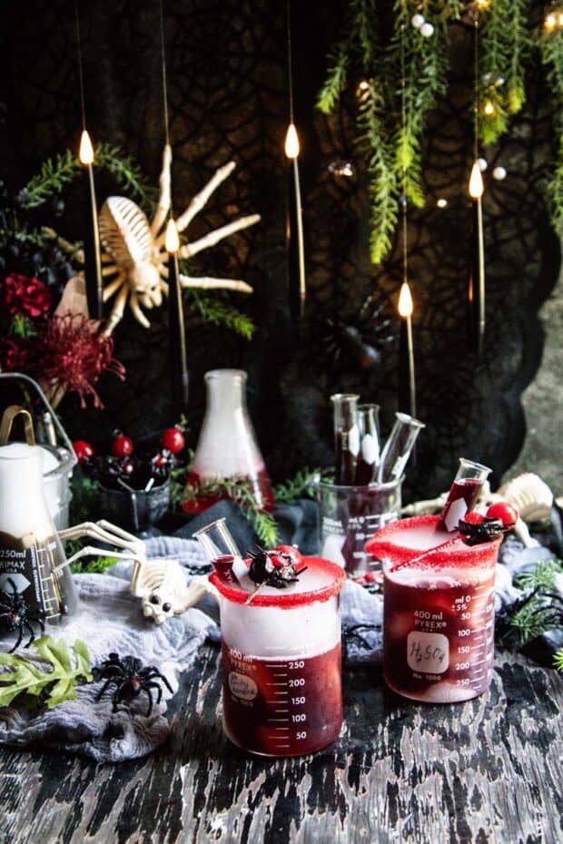 A spooky Halloween set up with spider decorations and cocktails fizzing and bubbling with dry ice.