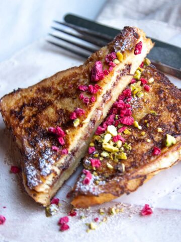 Eggnog stuffed French toast sliced in half to reveal the inside.