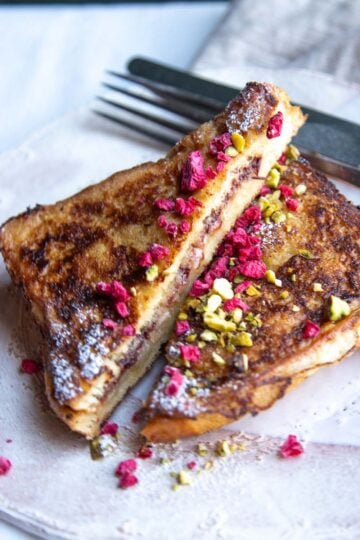 Eggnog stuffed French toast sliced in half to reveal the inside.