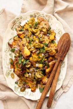 A platter of Crispy Smashed Potatoes with Dirty Martini-Infused Olive Topping ready to serve.