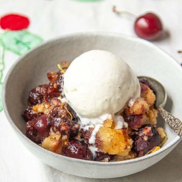 A bowl of Cherry Brown Betty with vanilla ice cream.